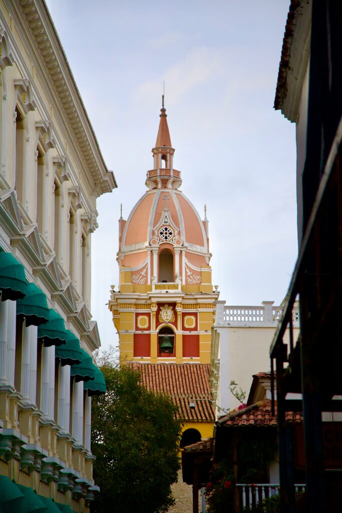Historic church tower framed by colonial buildings in Cartagena, Colombia